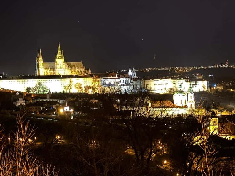 Prague: Night Walk through Prague Castle with City Views - Entering Prague Castle after dark, with a story that keeps pace
